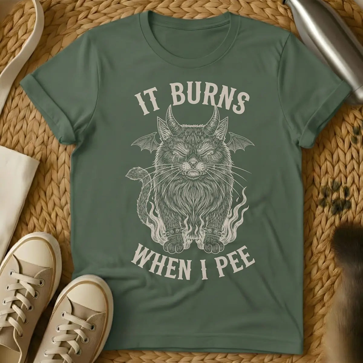 Military Green - A distressed illustration of a devil cat with horns, bat wings, tears, spiked bracelets, and flames, with the text "IT BURNS WHEN I PEE".