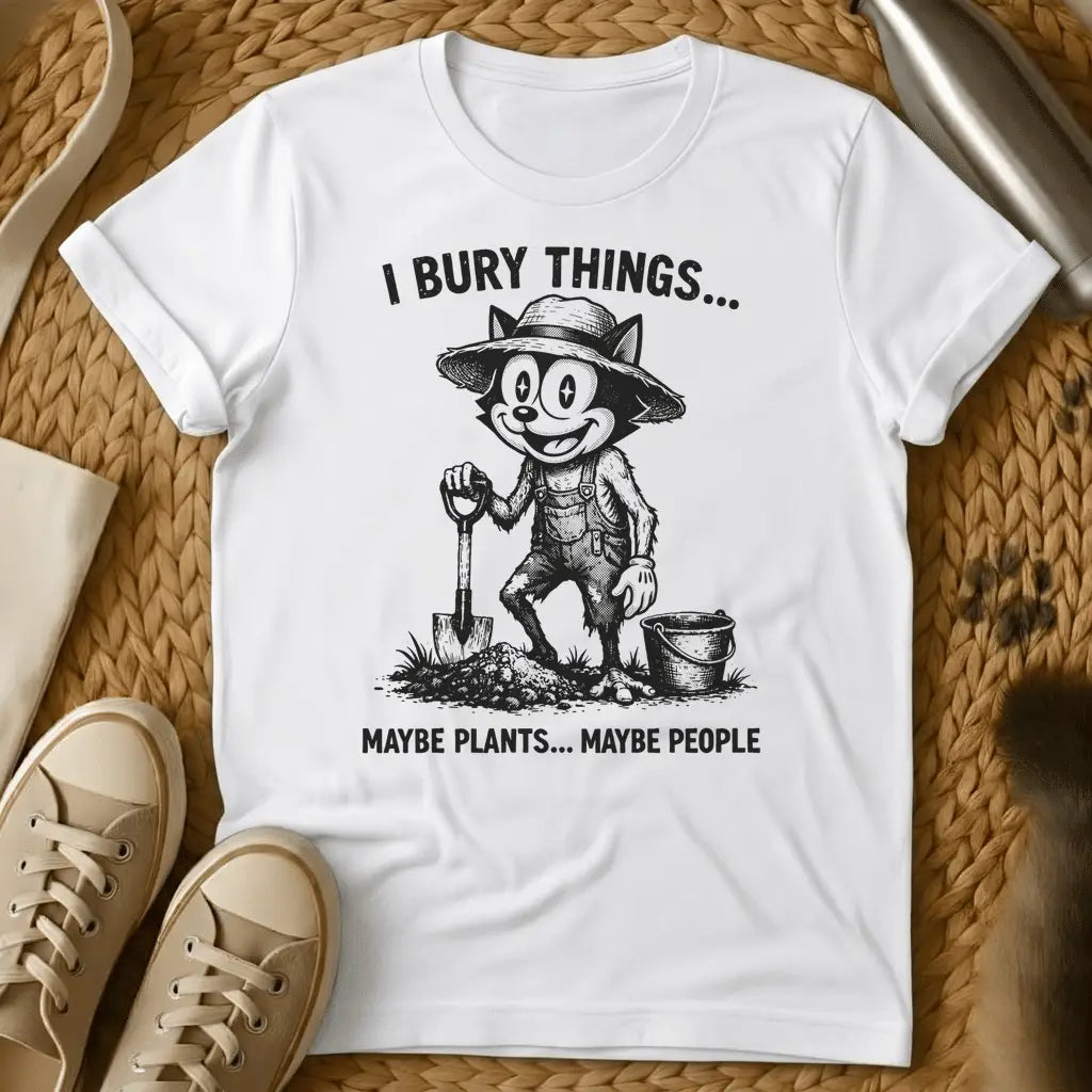 White - Vintage-style graphic tee featuring a grinning cat character in gardening clothes holding a shovel with text "I bury things... maybe plants... maybe p