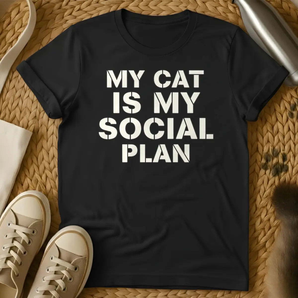 Black - T-shirt design featuring the text "MY CAT IS MY SOCIAL PLAN" in an off-white stencil font.