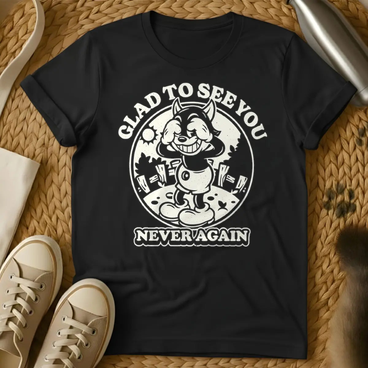 Black - Vintage style cartoon wolf character covering its eyes with its hands and grinning widely, in a circular frame with a sun and fence in the background. Arched text above the circle reads "GLAD TO SEE YOU", and text below the circle reads "NEVER AGAIN".