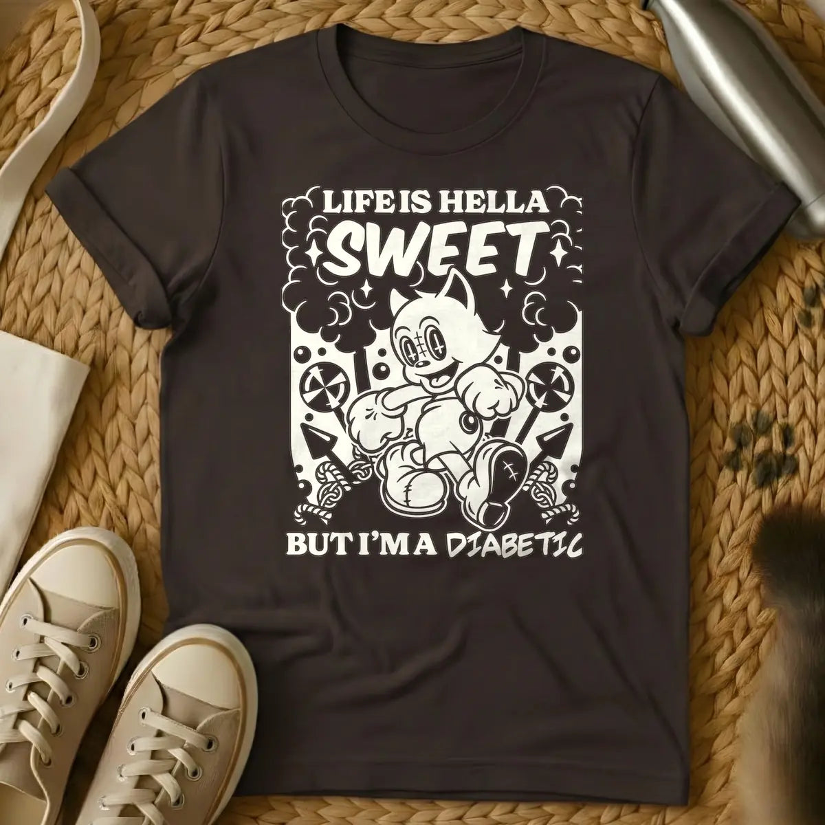 Dark Chocolate - Monochrome t-shirt design featuring a cheerful, running vintage cartoon cat amidst clouds, stars, lollipops, and candy canes. Above the cat, the text reads 'LIFE IS HELLA SWEET' in a bold, curvy font, with 'SWEET' being prominent. Below the cat, 'BUT I'M A DIABETIC' is written in a contrasting, handwritten style.