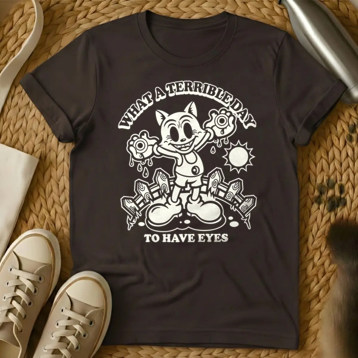 Dark Chocolate - Cream retro cartoon character, resembling a grinning cat with large eyes, holding two dripping eyeballs in its hands. Behind it are a picket fence and a bright sun. Arched text above reads "WHAT A TERRIBLE DAY" and straight text below reads "TO HAVE EYES".