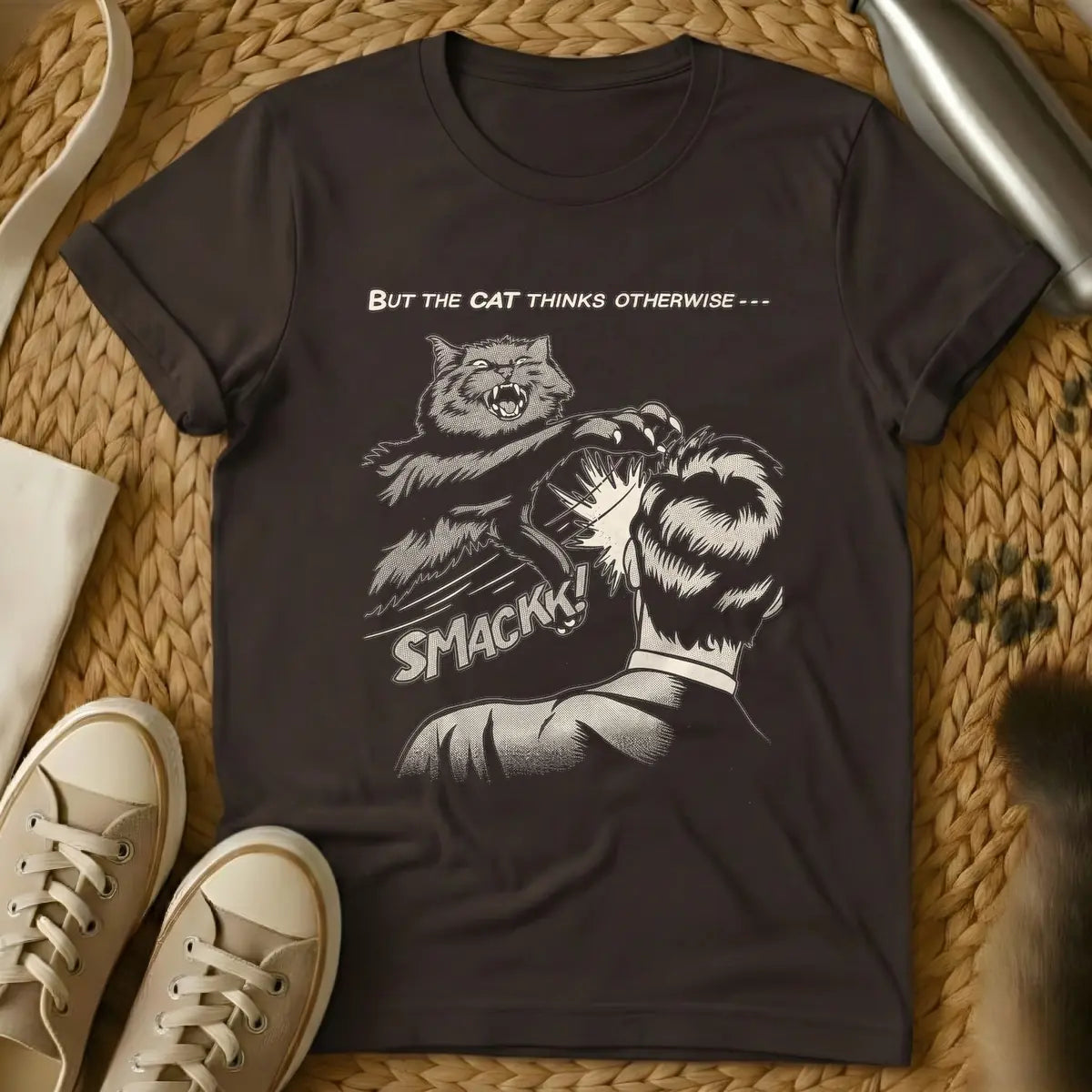 Dark Chocolate - Vintage comic book style illustration in beige tones with halftone shading. An angry cat with sharp claws is mid-air, slapping the back of a person's head. Below the action, the word 'SMACKK!' appears in a bold comic font. Above the scene, the text reads 'BUT THE CAT THINKS OTHERWISE ---'.