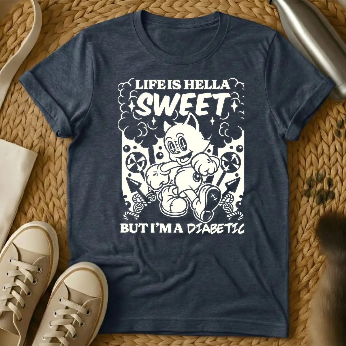 Heather Navy - Monochrome t-shirt design featuring a cheerful, running vintage cartoon cat amidst clouds, stars, lollipops, and candy canes. Above the cat, the text reads 'LIFE IS HELLA SWEET' in a bold, curvy font, with 'SWEET' being prominent. Below the cat, 'BUT I'M A DIABETIC' is written in a contrasting, handwritten style.
