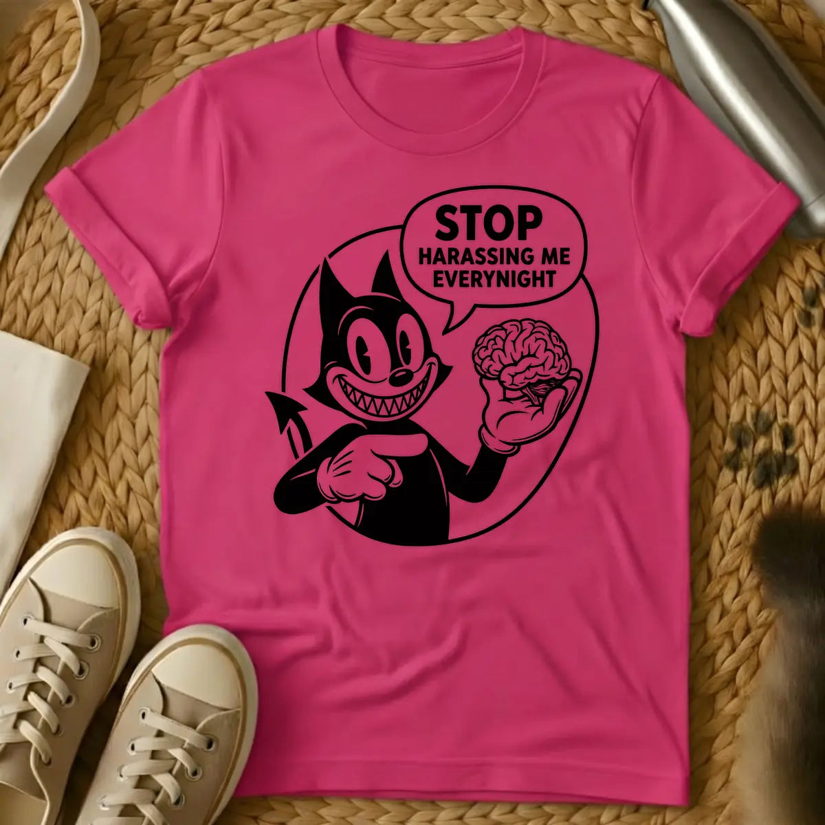 Heliconia - Black and white vintage cartoon devil cat with a wide, sharp-toothed grin, holding a human brain in one hand and pointing at it, with a speech bubble that reads "STOP HARASSING ME EVERY NIGHT".