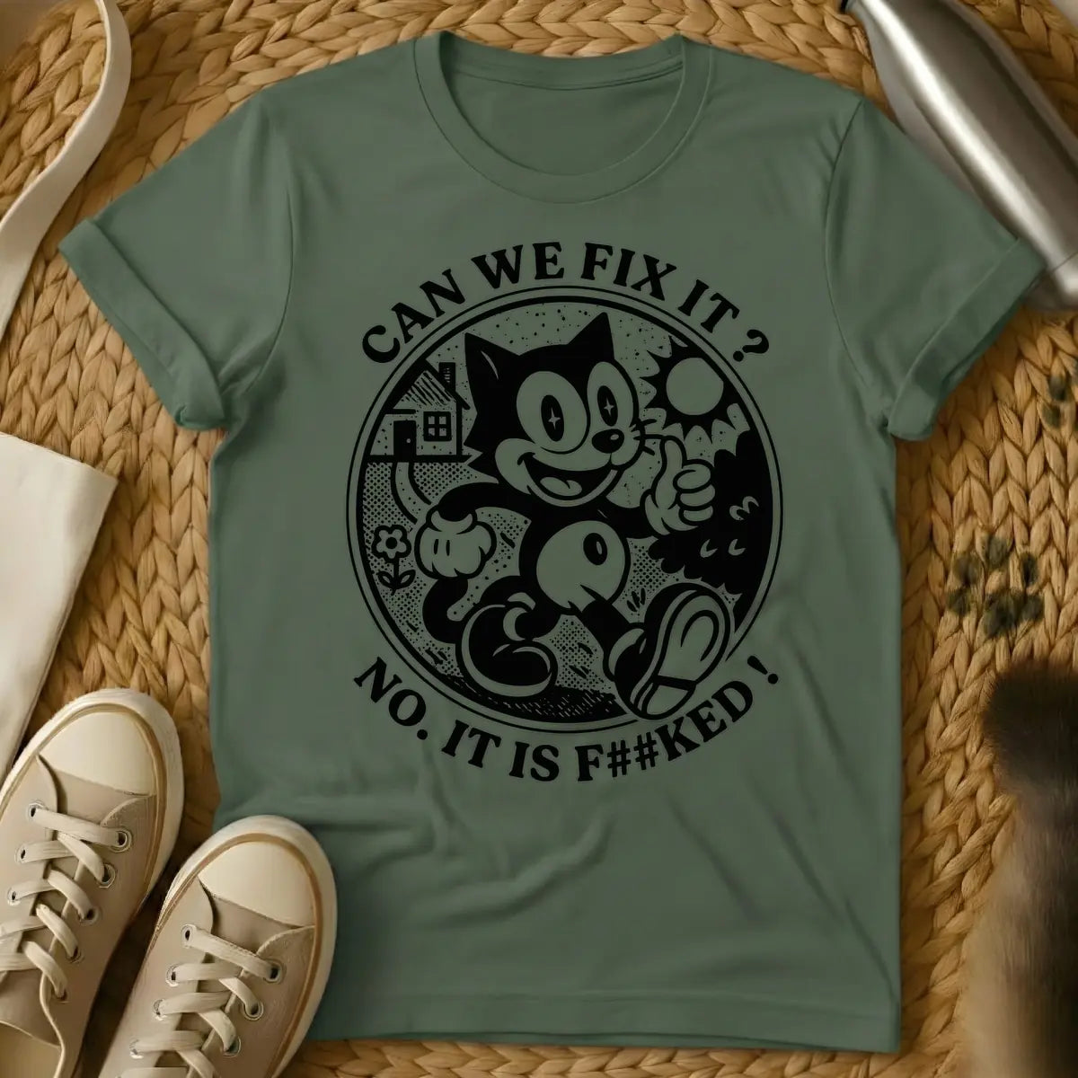 Military Green - Distressed cream-colored vintage cartoon cat, similar to Felix, with star-sparkle eyes, smiling and giving a thumbs up inside a circular border with a small house, flower, and sunburst. Arched text above the circle reads "CAN WE FIX IT?" and arched text below reads "NO. IT IS F##KED!".