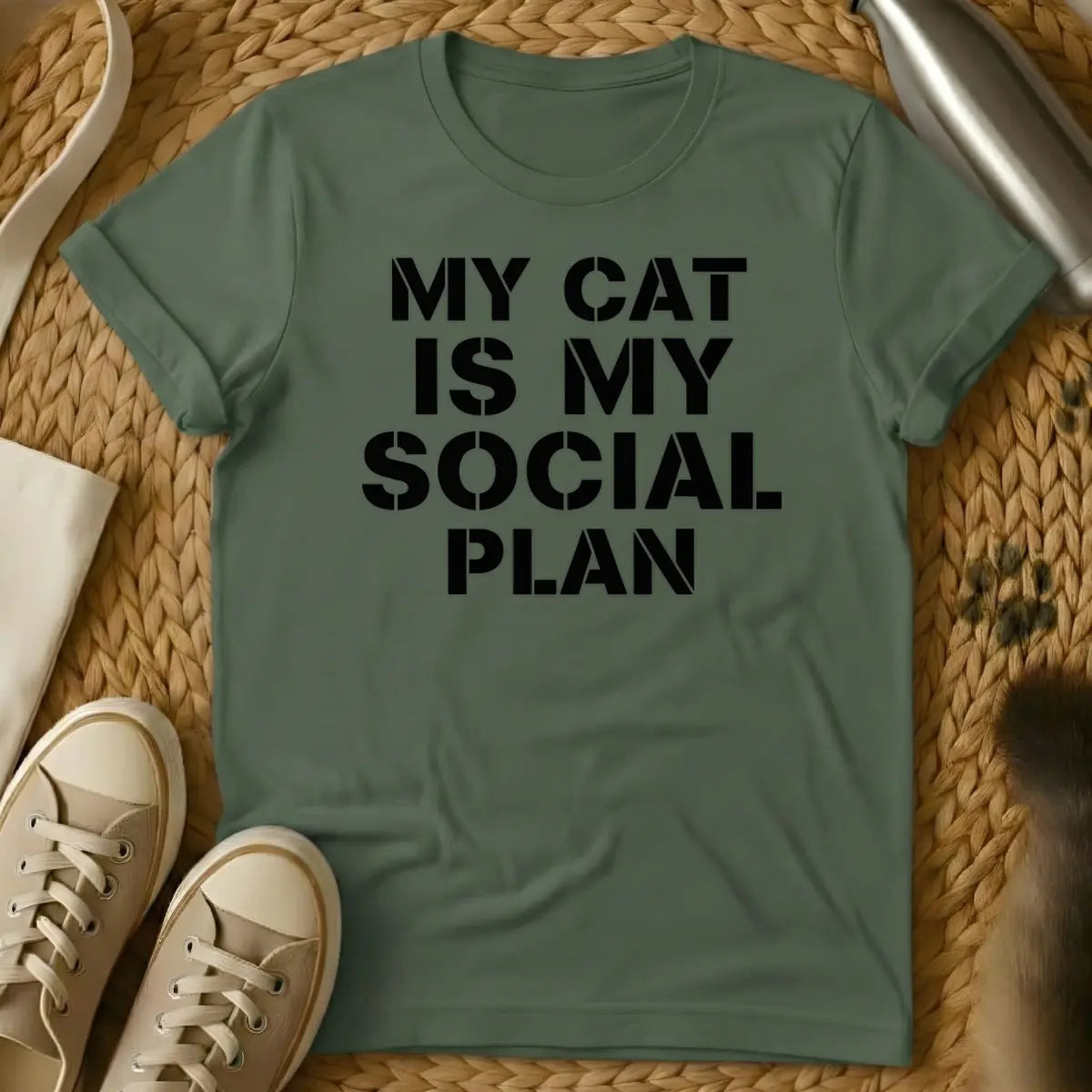 Military Green - T-shirt design featuring the text "MY CAT IS MY SOCIAL PLAN" in an off-white stencil font.