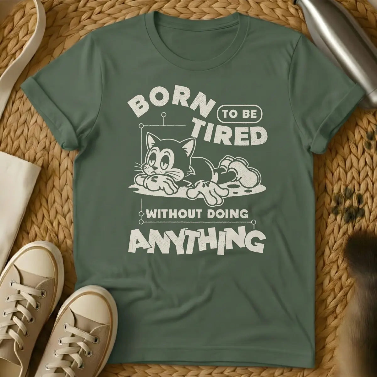 Military Green - Distressed cream t-shirt design featuring a tired-looking cartoon cat lying down and the text 'BORN TO BE TIRED WITHOUT DOING ANYTHING'.