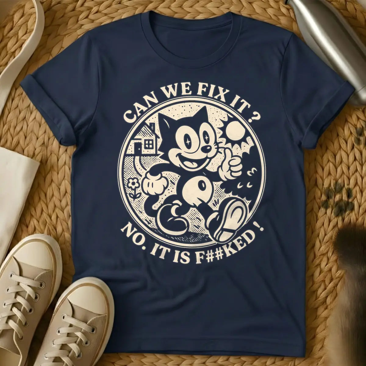 Navy - Distressed cream-colored vintage cartoon cat, similar to Felix, with star-sparkle eyes, smiling and giving a thumbs up inside a circular border with a small house, flower, and sunburst. Arched text above the circle reads "CAN WE FIX IT?" and arched text below reads "NO. IT IS F##KED!".