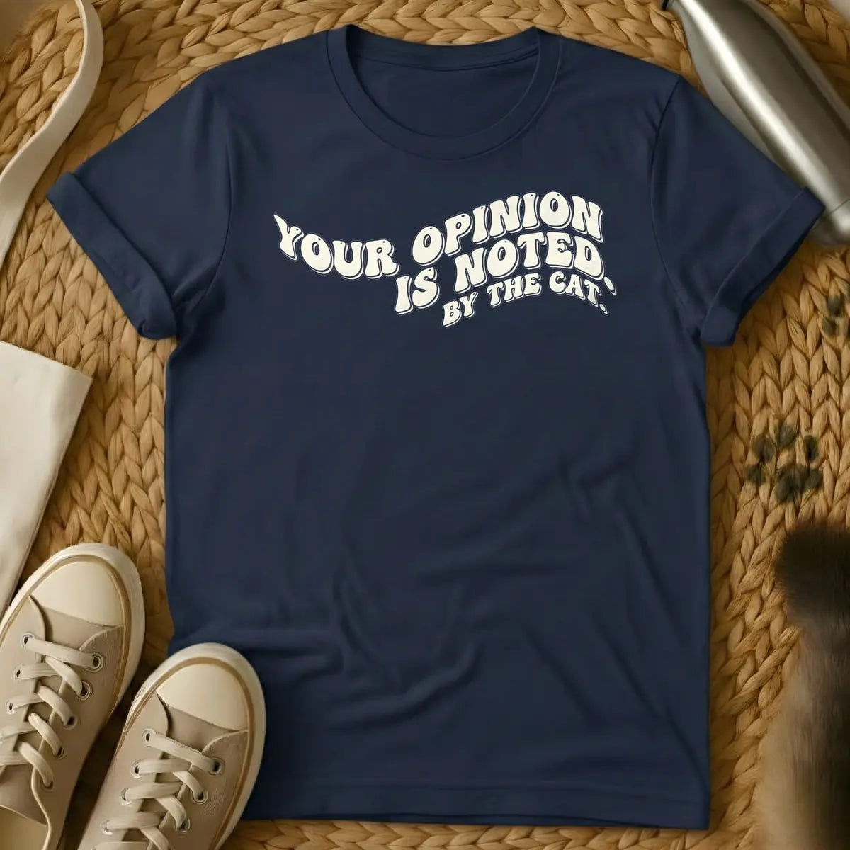 Navy - T-shirt design featuring the phrase "YOUR OPINION IS NOTED BY THE CAT." in a cream, bubbly retro font.