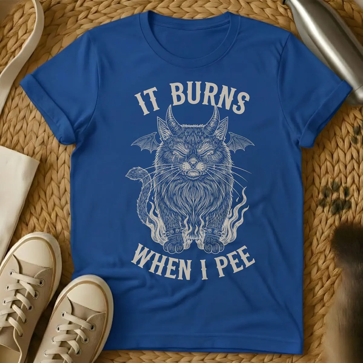 Royal - A distressed illustration of a devil cat with horns, bat wings, tears, spiked bracelets, and flames, with the text "IT BURNS WHEN I PEE".