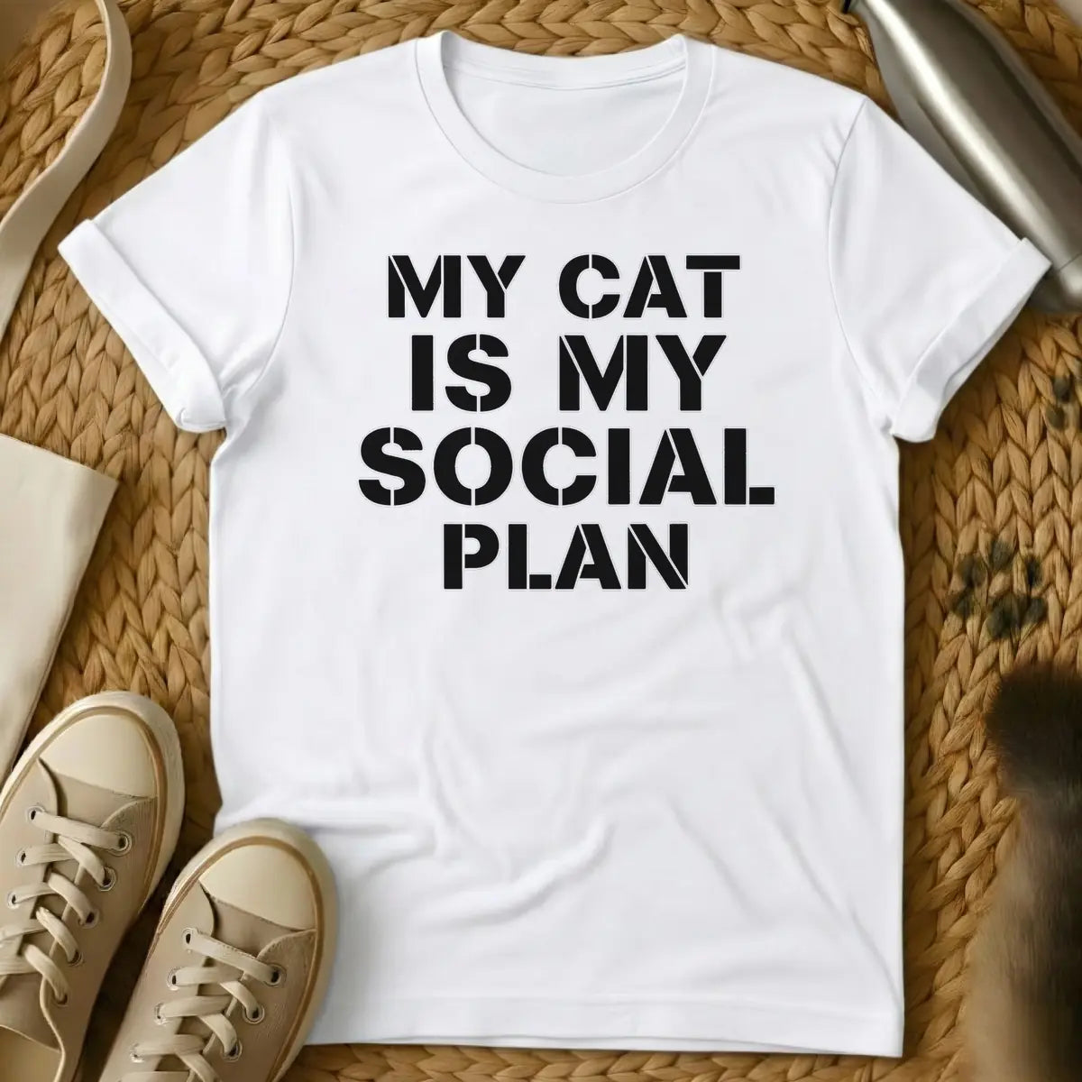 White - T-shirt design featuring the text "MY CAT IS MY SOCIAL PLAN" in an off-white stencil font.