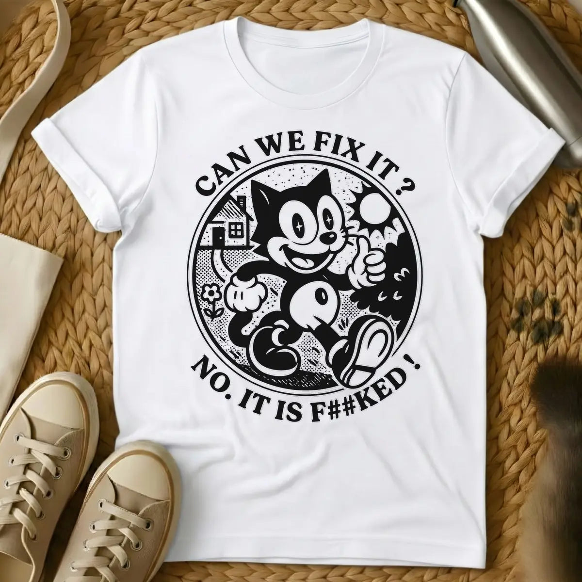 White - Distressed cream-colored vintage cartoon cat, similar to Felix, with star-sparkle eyes, smiling and giving a thumbs up inside a circular border with a small house, flower, and sunburst. Arched text above the circle reads "CAN WE FIX IT?" and arched text below reads "NO. IT IS F##KED!".