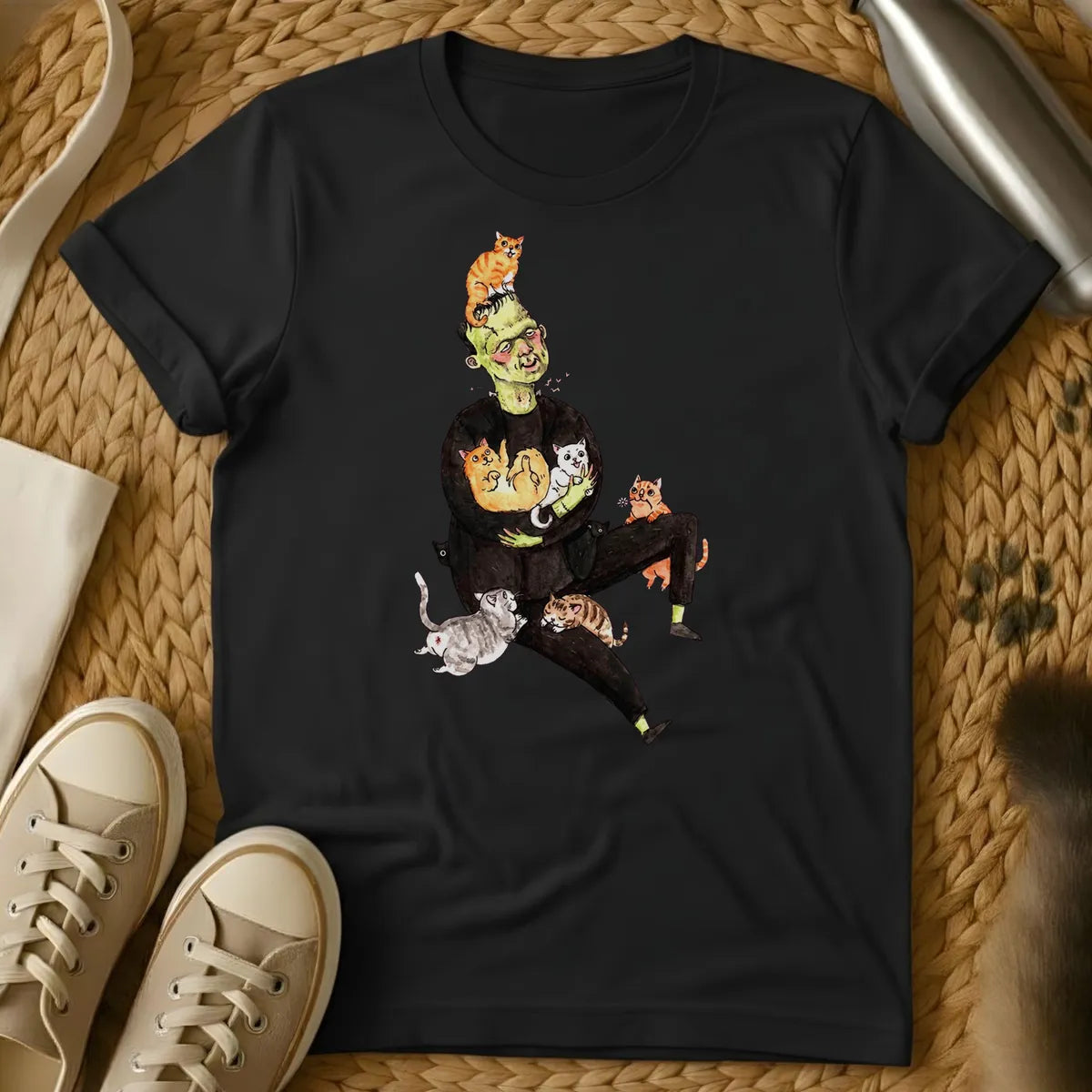 Black - Frankenstein's monster juggling colorful cats on a sage green t-shirt with whimsical cartoon illustration style