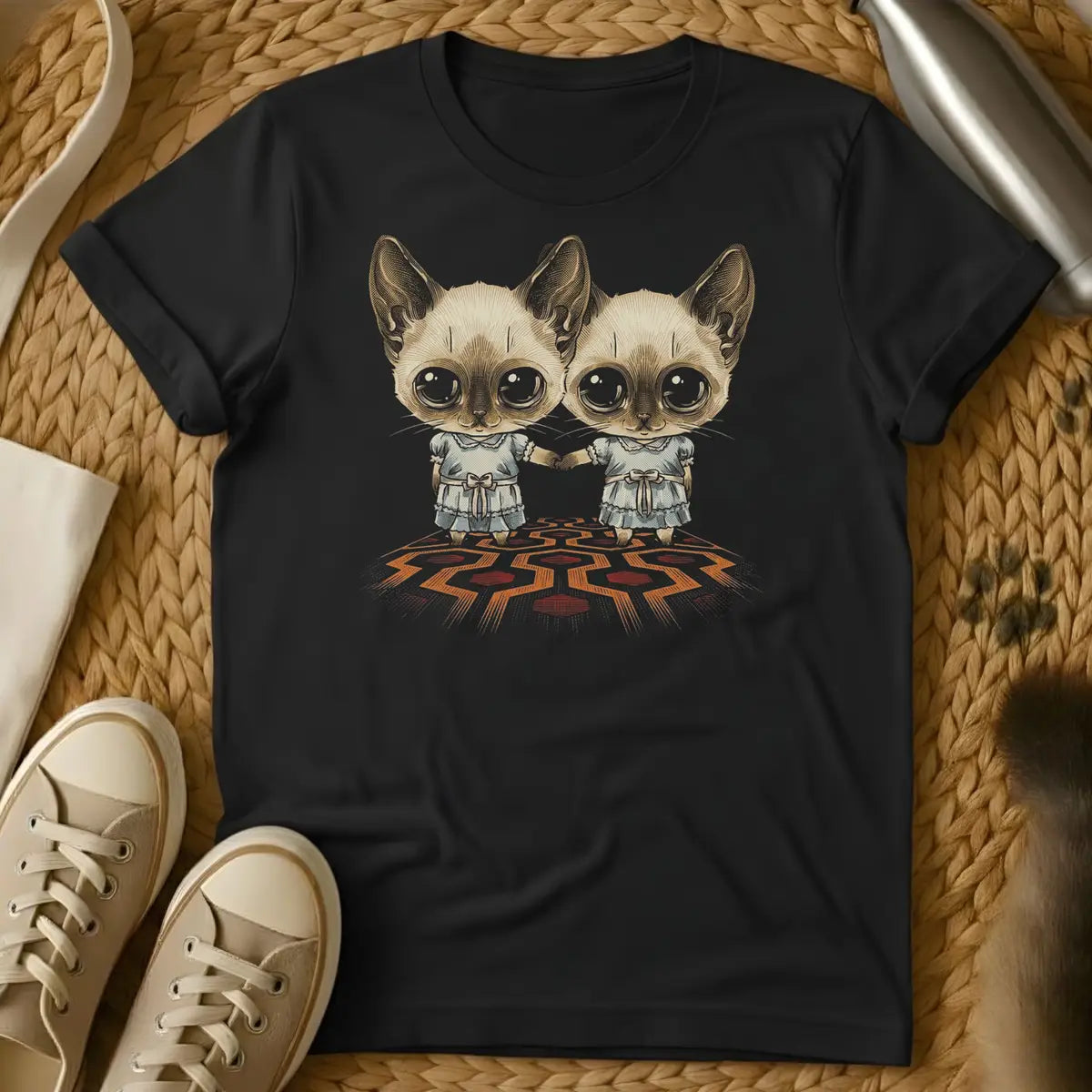 Black - Dark gray t-shirt with two wide-eyed Siamese kittens in matching blue pinafore dresses holding hands on a red hexagonal carpet pattern
