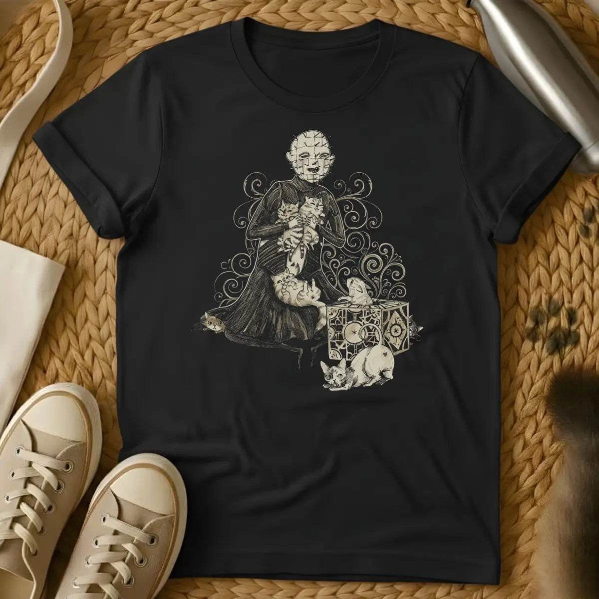 Black - Dark brown t-shirt with white line art illustration of a skeletal figure in robes holding cats, surrounded by ornate decorative swirls and mystical sy
