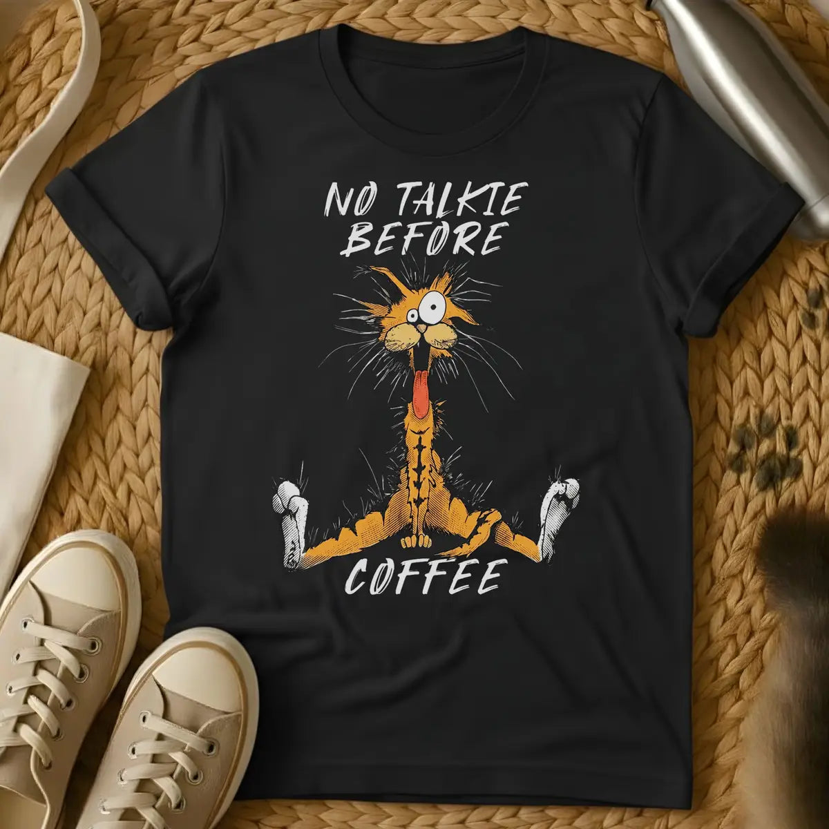 Black - Dark grey t-shirt with a wild-eyed frantic orange cartoon cat mouth open fur standing on end text reads No Talkie Before Coffee