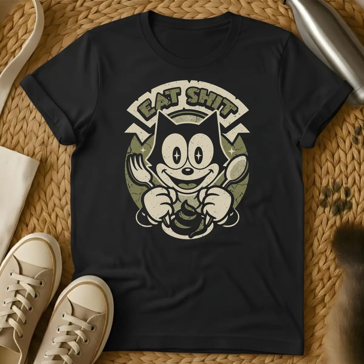 Black - Dark grey t-shirt with a retro cartoon cat holding fork and spoon over a poop emoji with text reading Eat Shit in a vintage badge design