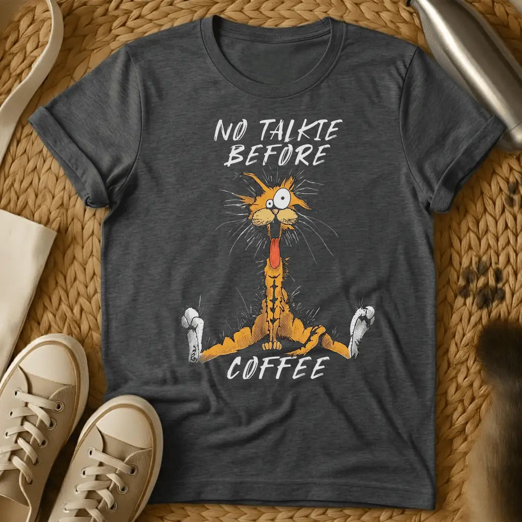 Dark Heather - Dark grey t-shirt with a wild-eyed frantic orange cartoon cat mouth open fur standing on end text reads No Talkie Before Coffee