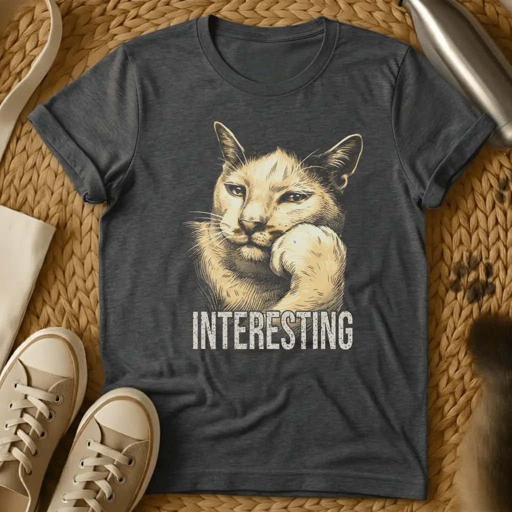 Dark Heather - Dark heather t-shirt with vintage engraving-style illustration of a cat resting chin on paw and the word INTERESTING below