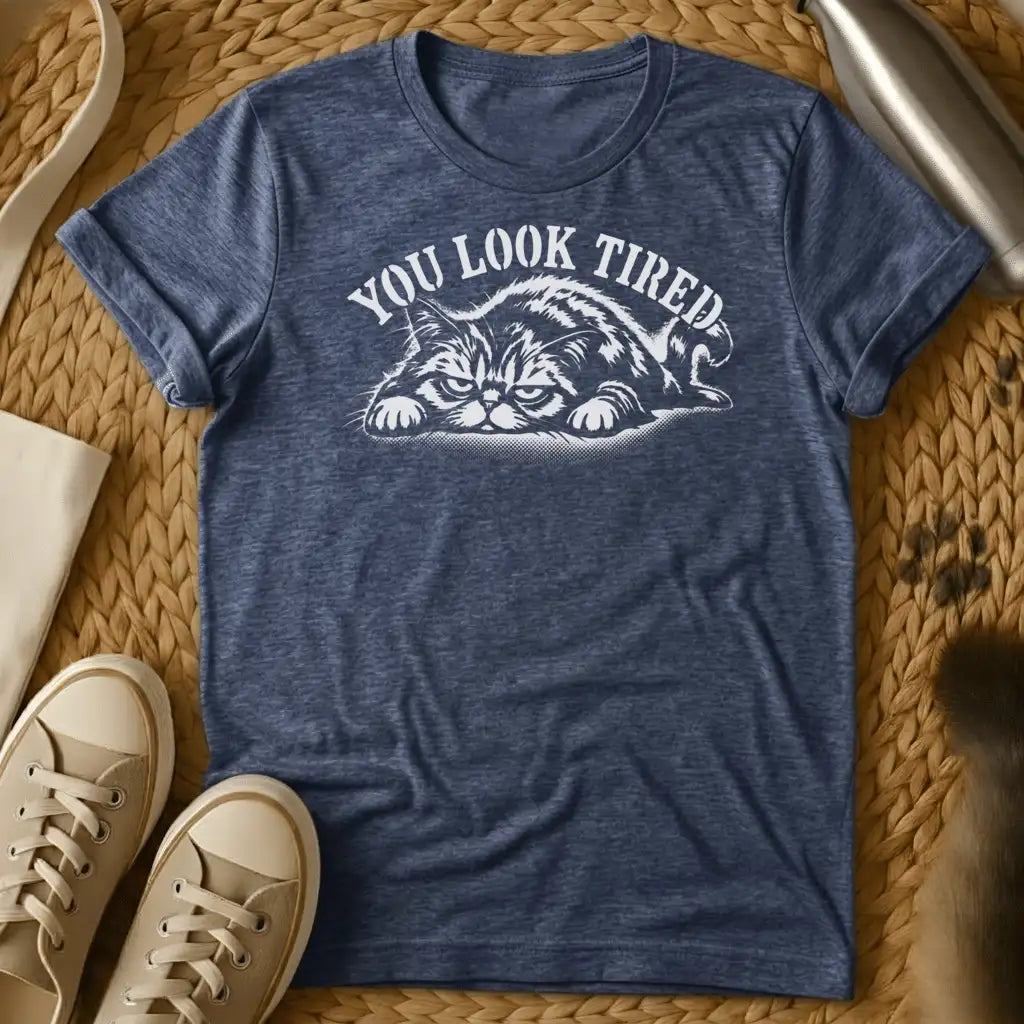 Heather Navy - Dark heather grey t-shirt with a grumpy lounging cat woodcut illustration and arched text reading You Look Tired