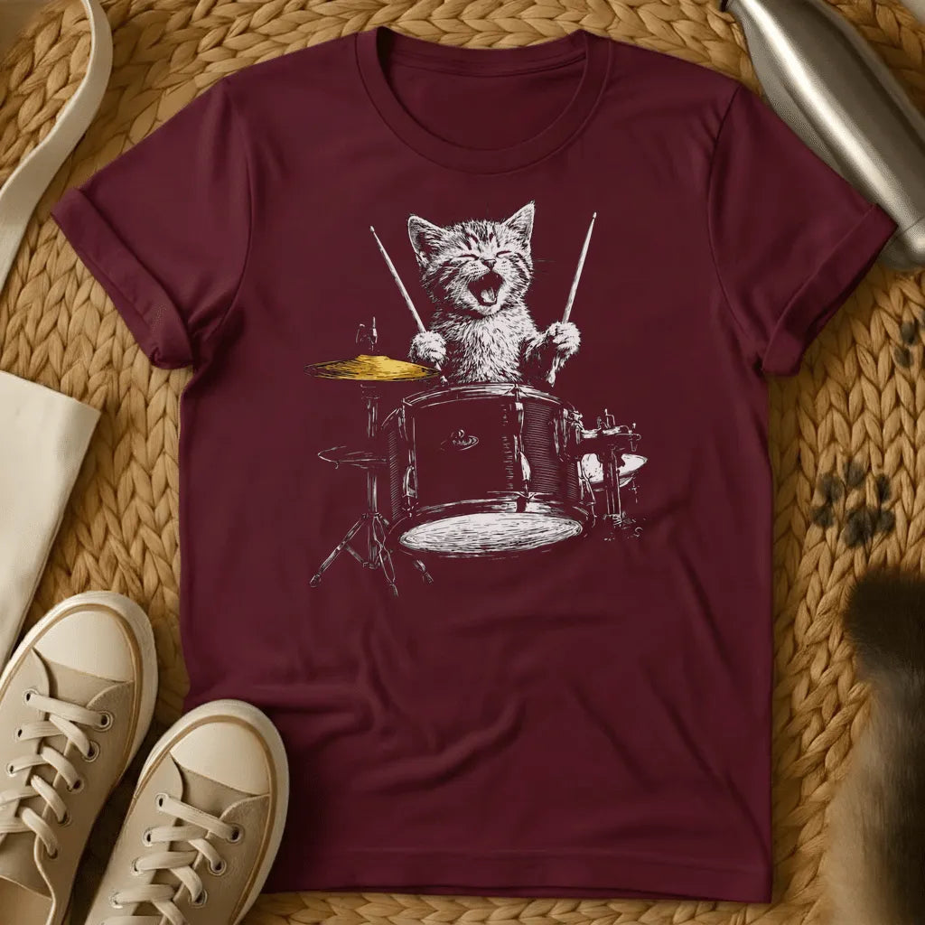 Maroon - Forest green t-shirt with a sketch of a happy kitten playing a full drum kit with drumsticks, mouth open, cymbal mid-crash