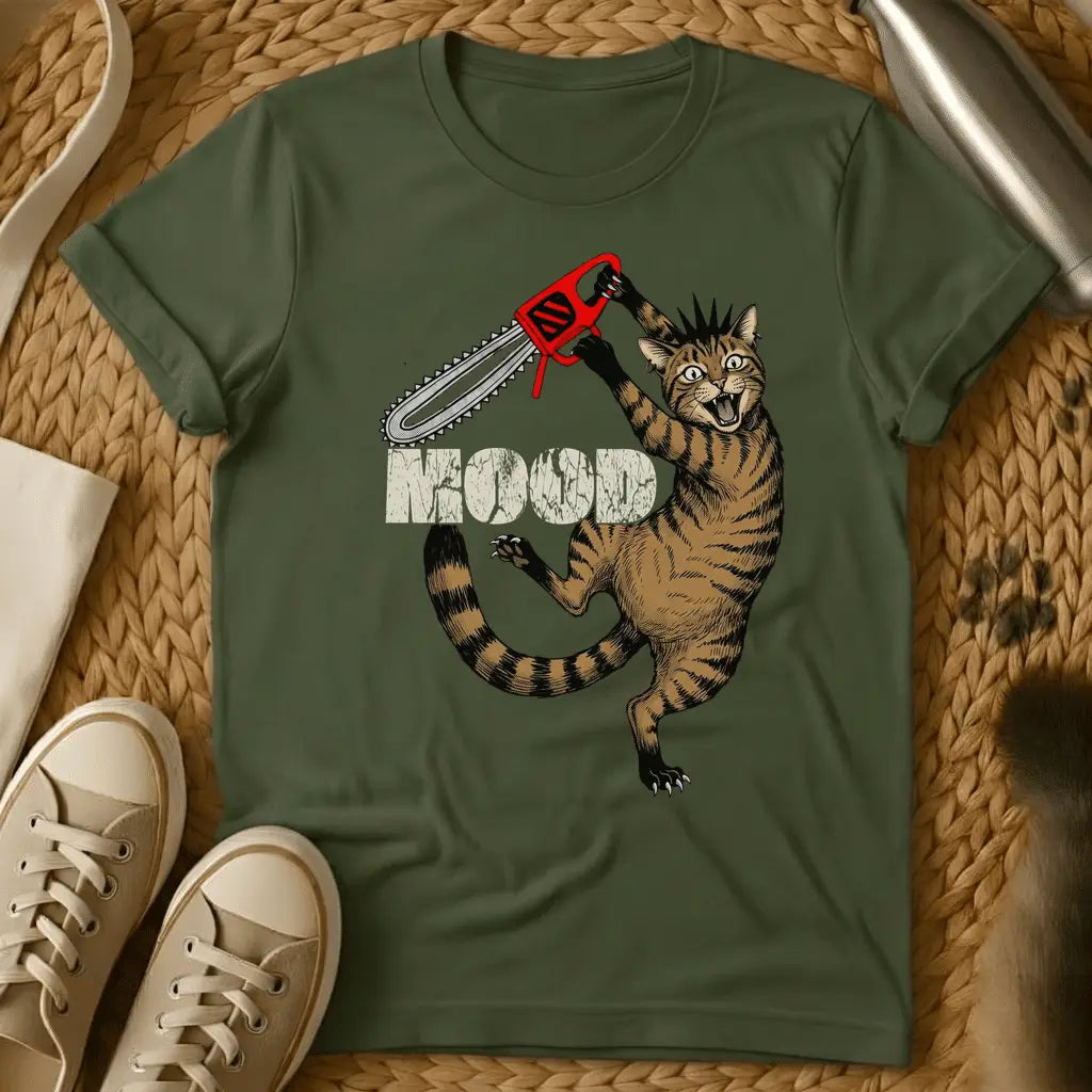 Military Green - Cartoon cat holding red chainsaw with "MOOD" text on olive green t-shirt, displayed flat lay with sneakers