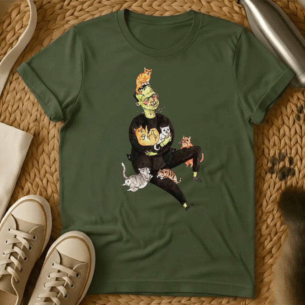 Military Green - Frankenstein's monster juggling colorful cats on a sage green t-shirt with whimsical cartoon illustration style