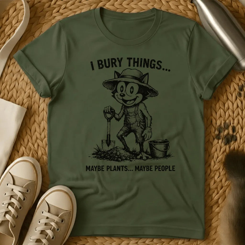Military Green - Vintage-style graphic tee featuring a grinning cat character in gardening clothes holding a shovel with text "I bury things... maybe plants... maybe p