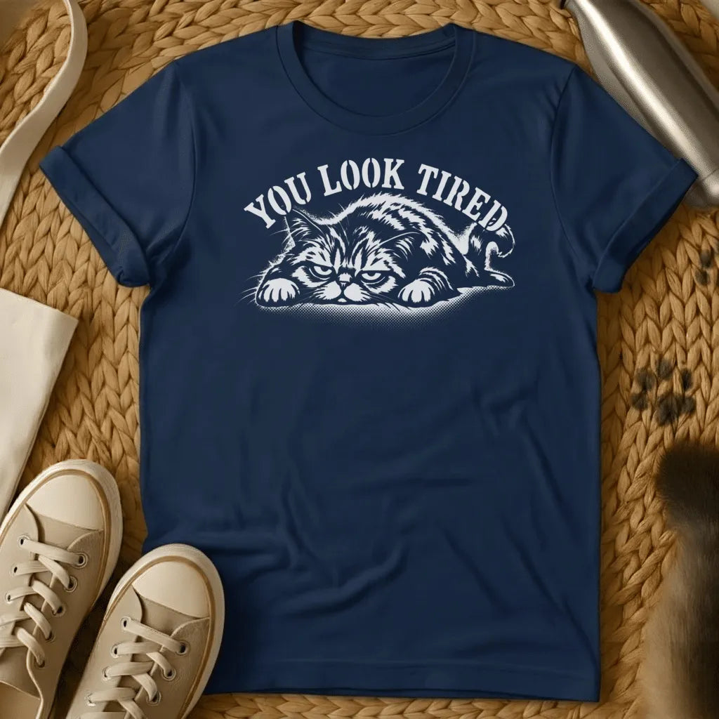 Navy - Dark heather grey t-shirt with a grumpy lounging cat woodcut illustration and arched text reading You Look Tired