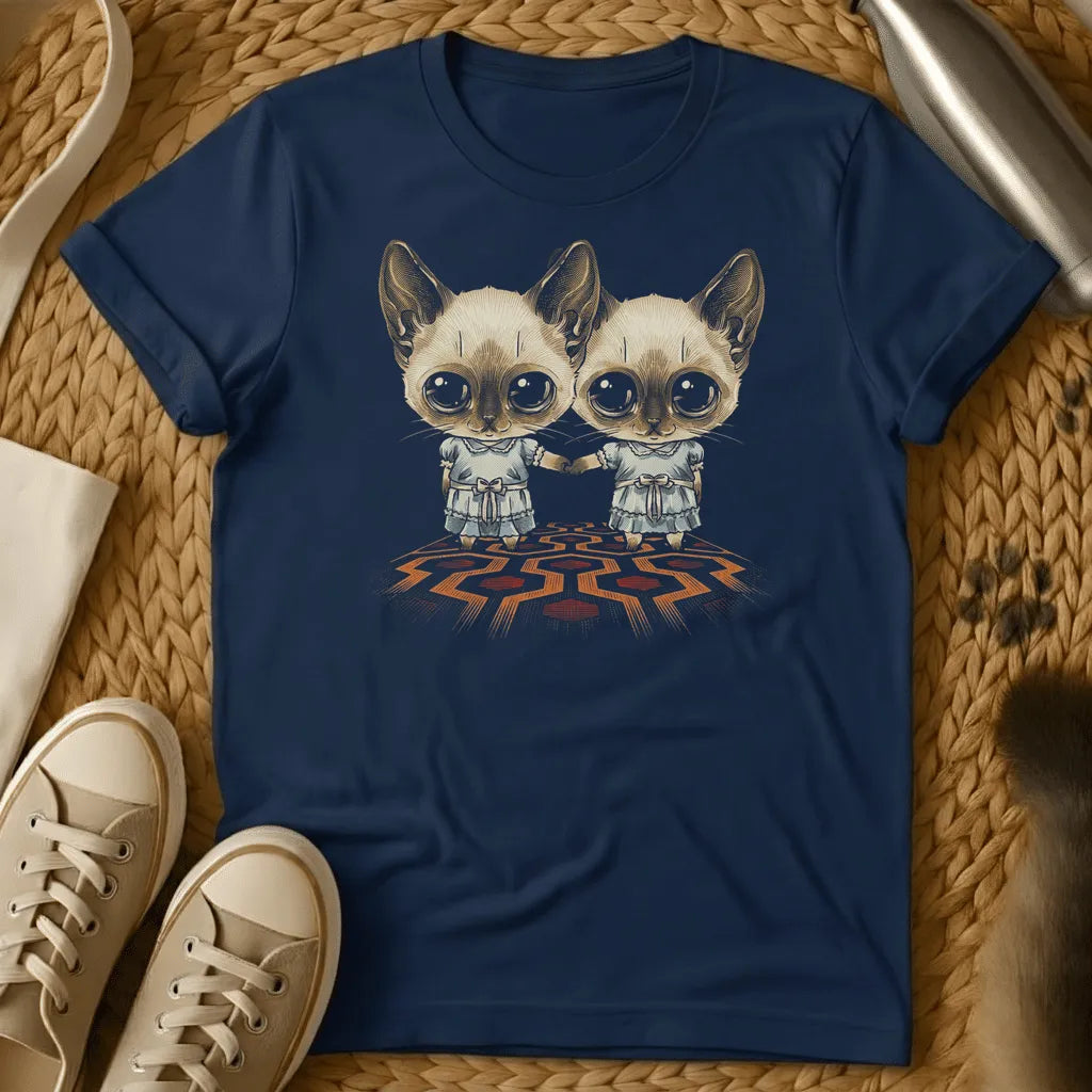 Navy - Dark heather t-shirt with two wide-eyed Siamese cats in frilly dresses holding hands on a geometric patterned carpet, creepy twin horror design