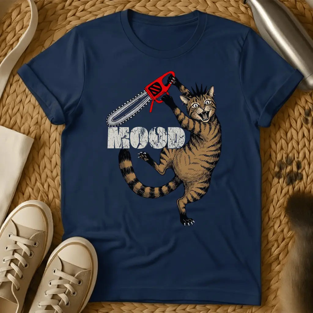 Navy - Cartoon cat holding red chainsaw with "MOOD" text on olive green t-shirt, displayed flat lay with sneakers