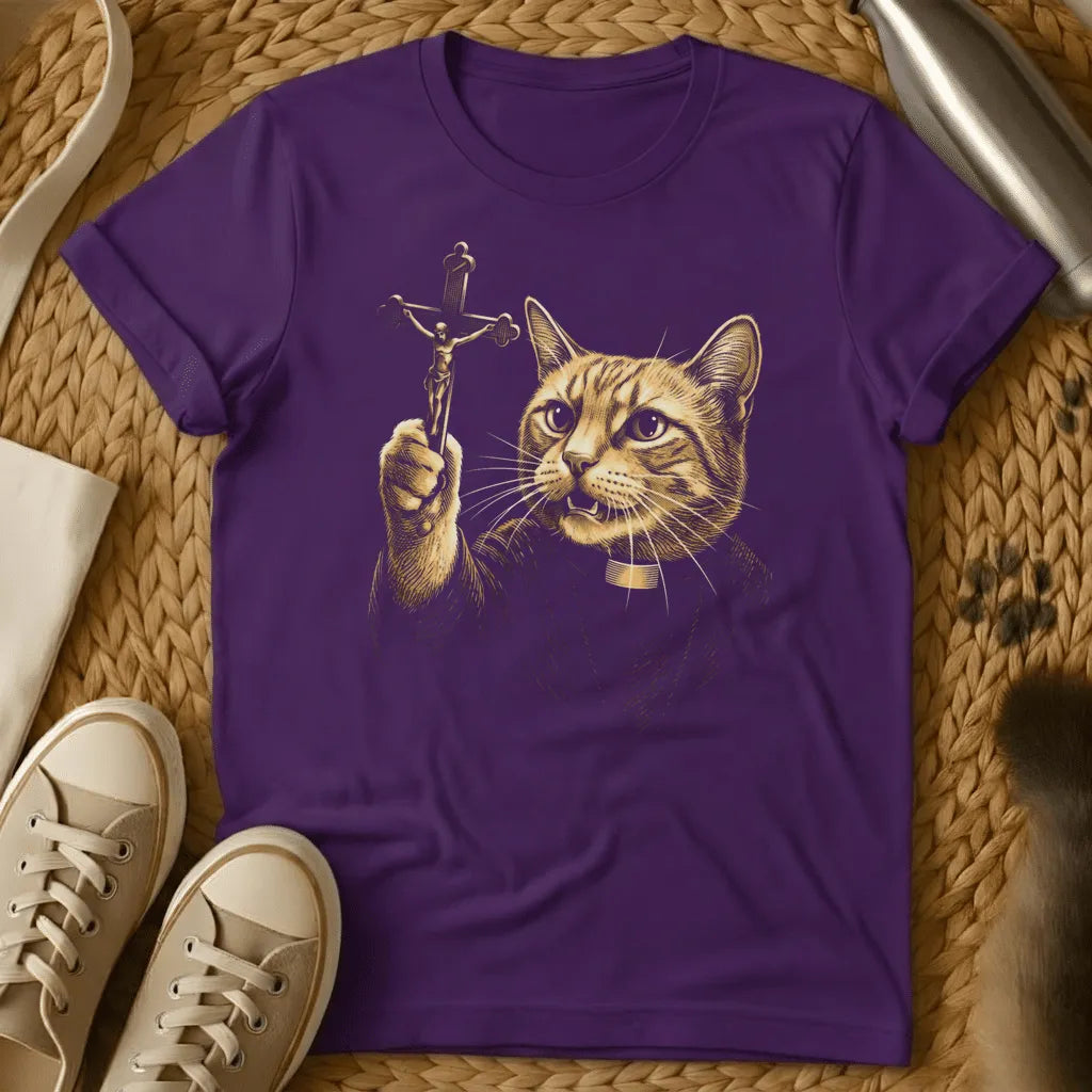 Purple - Cat holding crucifix with halo, gold religious artwork on charcoal gray t-shirt, flat lay styling