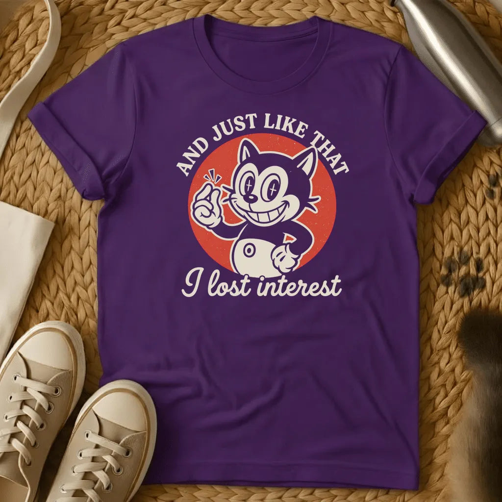Purple - Dark heather t-shirt with vintage rubber-hose cartoon grinning cat snapping fingers on red circle, text reads And Just Like That I Lost Interest