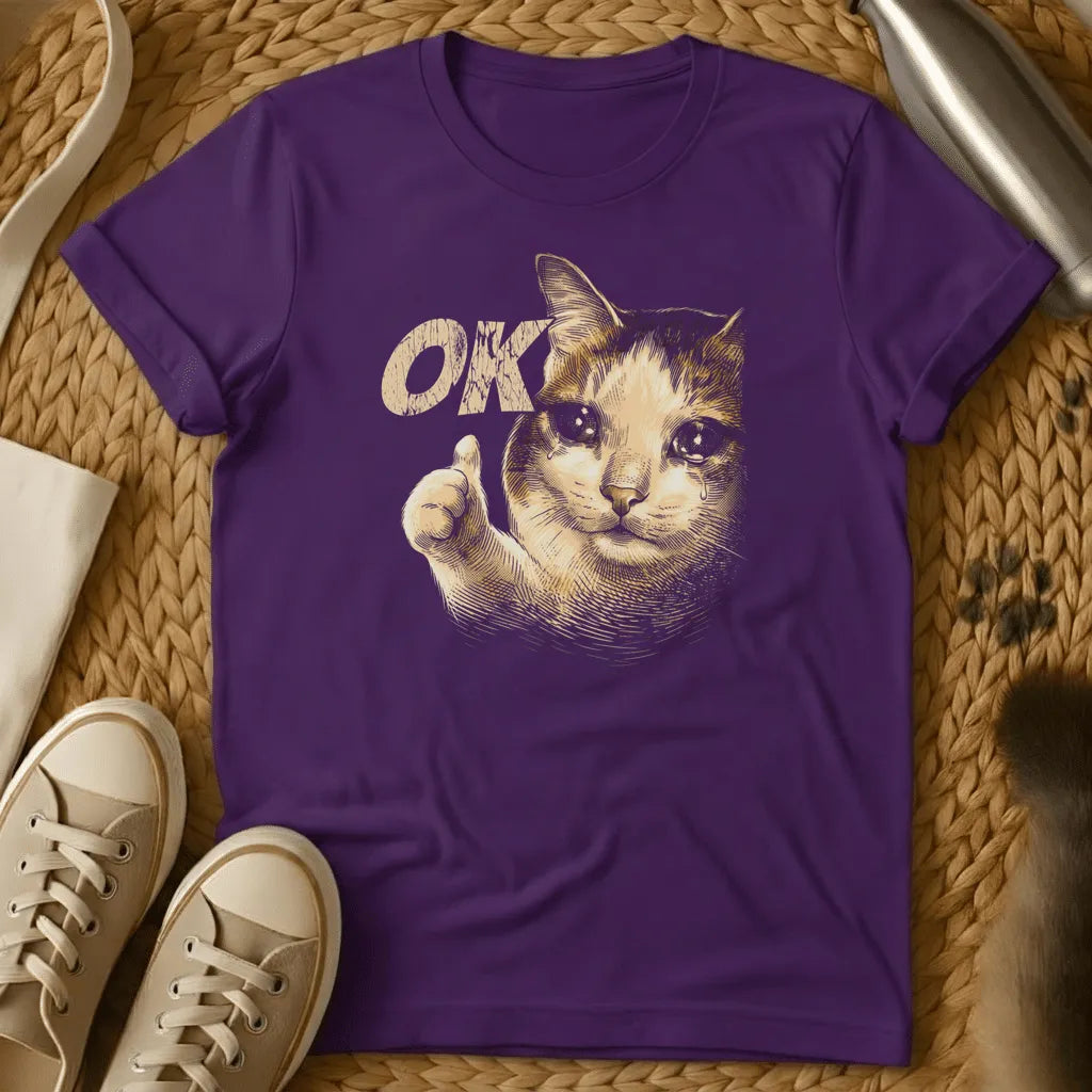 Purple - Dark heather t-shirt with a Victorian engraving of a crying cat giving a thumbs-up next to the word OK