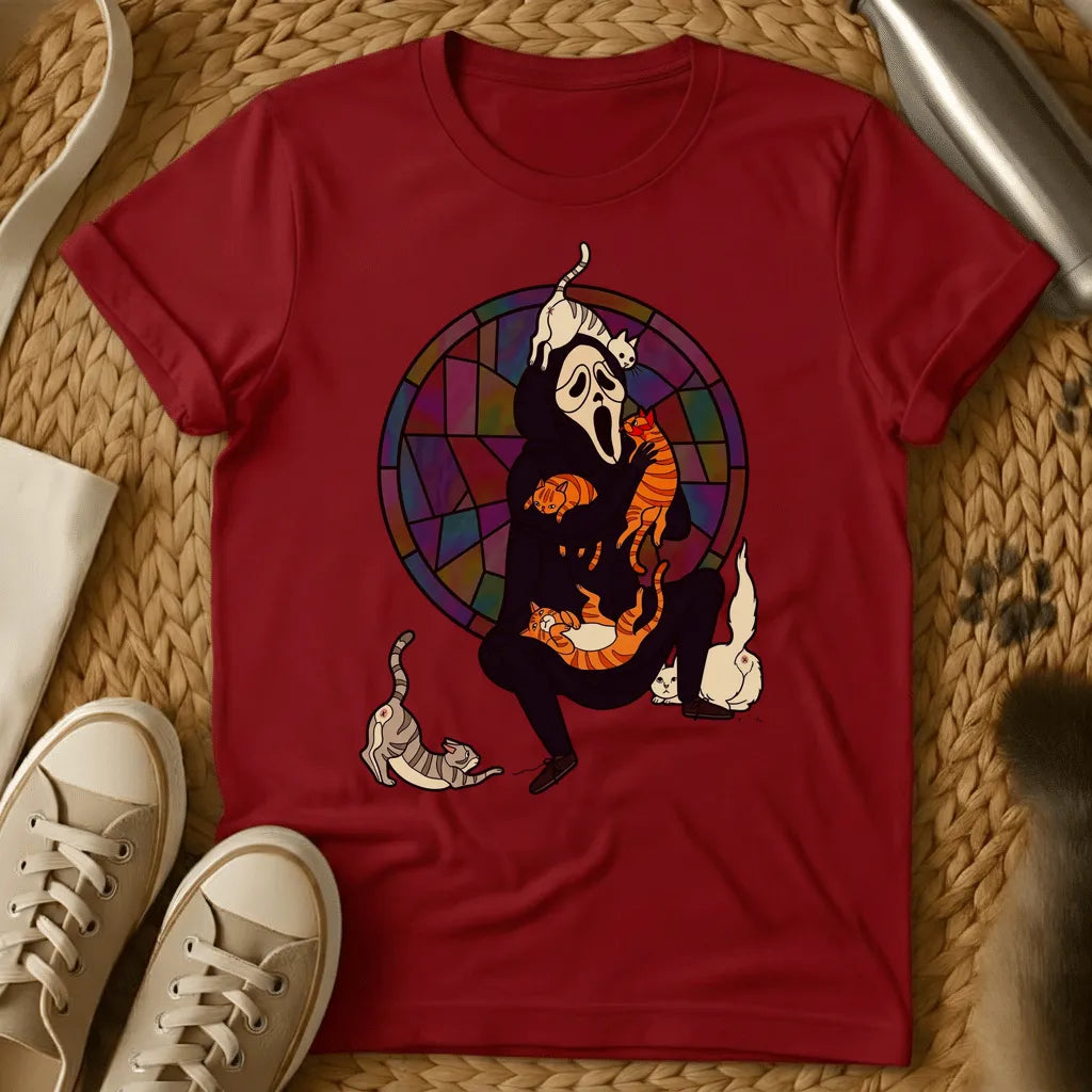 Red - Olive green t-shirt with a screaming ghost mask figure in black overwhelmed by multiple cats against a stained glass window backdrop