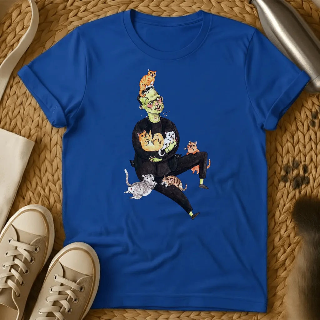 Royal - Frankenstein's monster juggling colorful cats on a sage green t-shirt with whimsical cartoon illustration style
