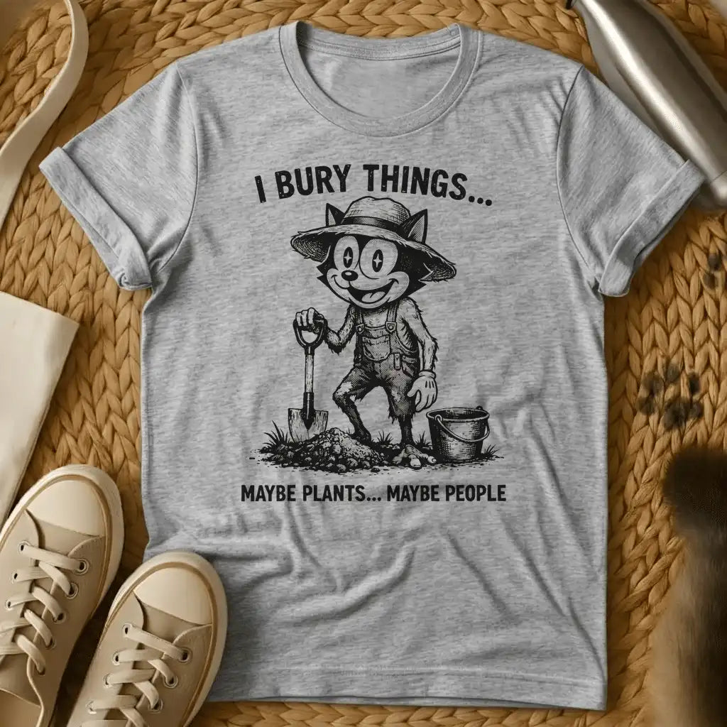 Sport Grey - Vintage-style graphic tee featuring a grinning cat character in gardening clothes holding a shovel with text "I bury things... maybe plants... maybe p